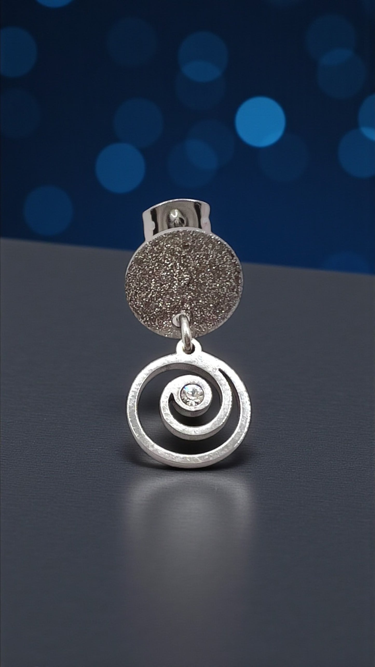 Mono orecchino Vortice in acciaio e zircone