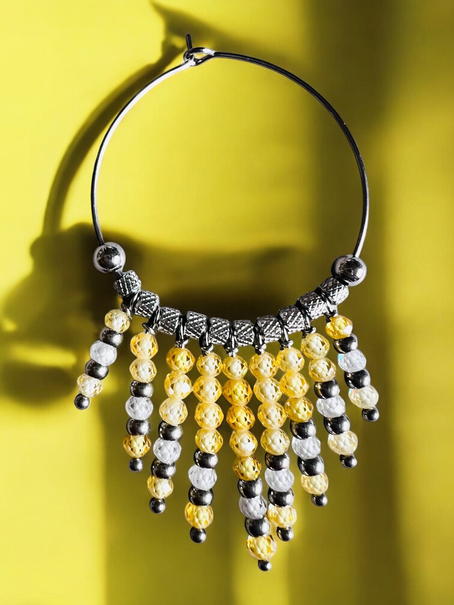 Mono orecchino in acciaio e zirconi