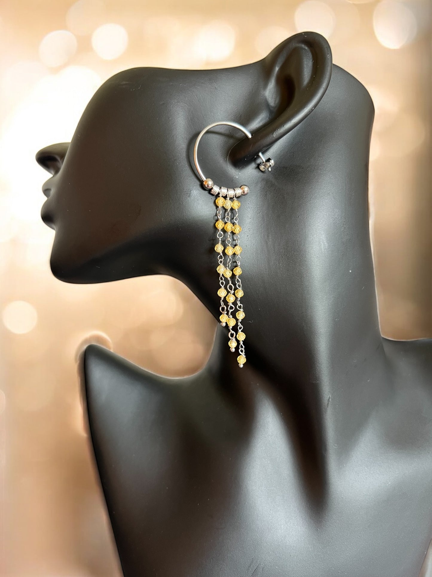 Mono orecchino in acciaio e zirconi gialli