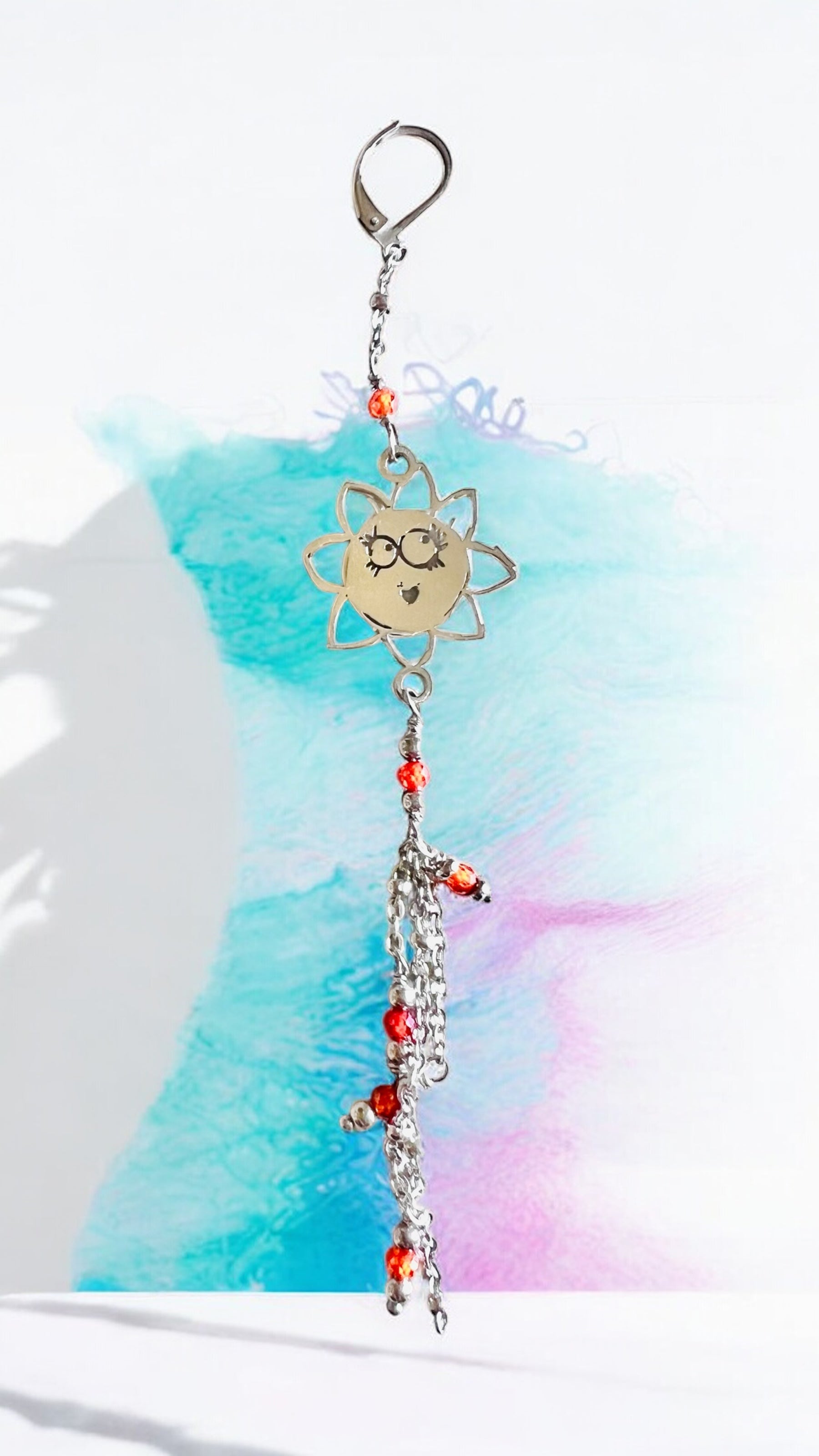 Mono orecchino in acciaio e zirconi arancioni