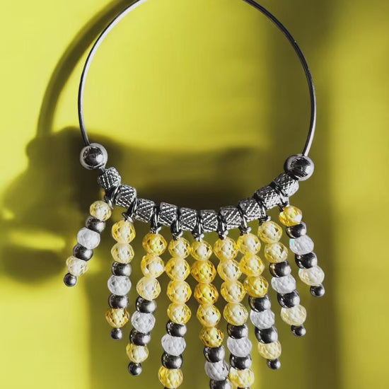 Mono orecchino in acciaio e zirconi gialli