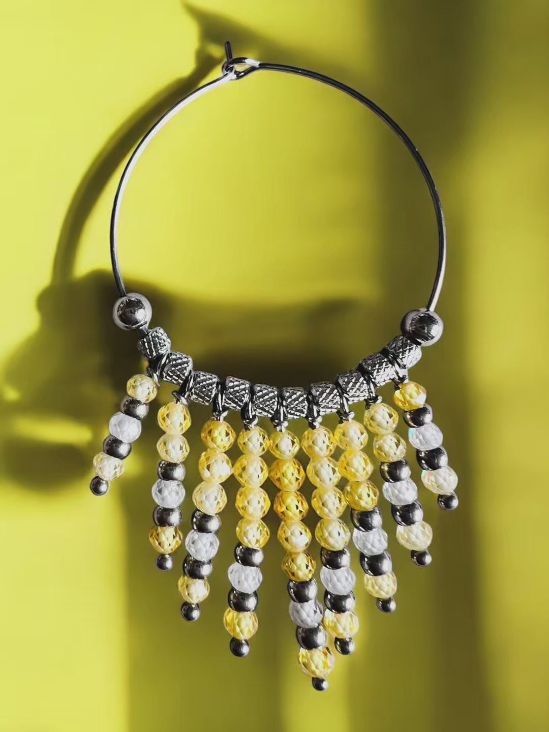 Mono orecchino in acciaio e zirconi gialli